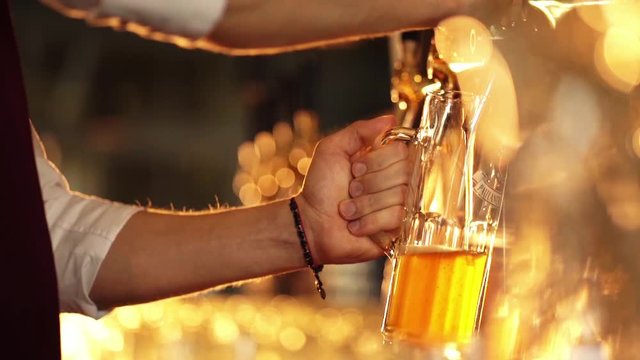 Male hands pour beer in a pub