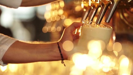 Male hands pour beer in a pub
