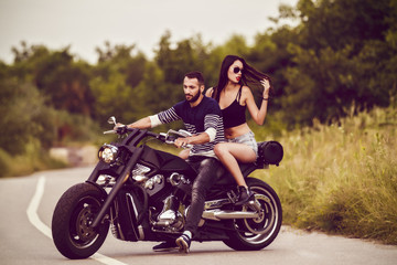Plakat Romantic picture with a couple of beautiful young bikers