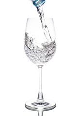 Water is poured in a glass wine transparent white background.