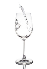 Water is poured in a glass wine transparent white background.