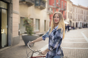 Naklejka na ściany i meble Young woman riding a bike