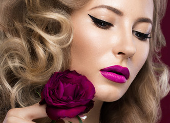 Fototapeta na wymiar Beautiful blonde in a Hollywood manner with curls, pink lips. Beauty face.
