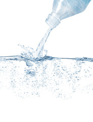 Plastic bottle puoring water and splashing against white background