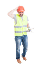 Male builder with tablet looking confused or doubtful