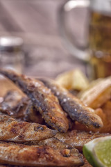 Fish and chips on wooden table with copy space