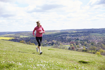 Mature Woman Jogging In Countryside