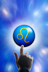 hand touching a button with the zodiac symbol of Leo