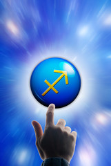 hand touching a button with the zodiac symbol of Sagittarius