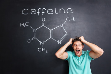 Crazy cheerful young professor of chemistry standing and shouting