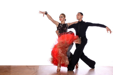 Latino dancers in ballroom against white background