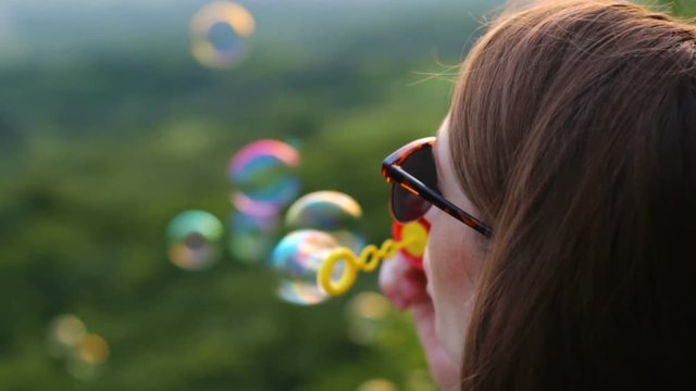 Young woman blow bubbles