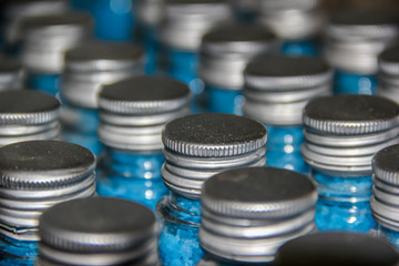 Conveyor with bottles filled with blue sea salt