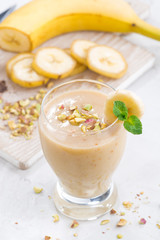 banana milkshake in a glass, top view, vertical
