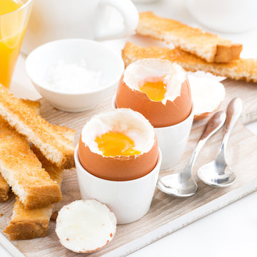 delicious breakfast with boiled eggs and crispy toasts