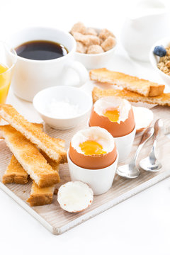 delicious breakfast with boiled eggs and crispy toasts, vertical