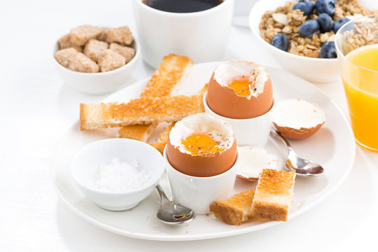 delicious breakfast with soft boiled eggs and crispy toasts 