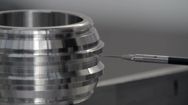 Coordinate measuring machine (CMM), inspecting a stainless steel component.