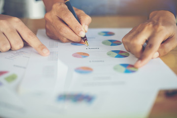 team business woman hands working and holding business graph.