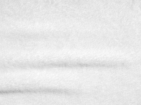 Creased white cloth material fragment as a background texture
