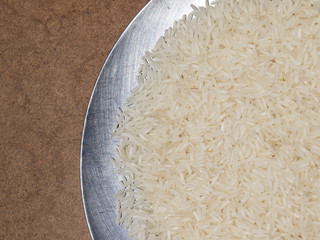 Close up white rice on the wooden plate and rice plant