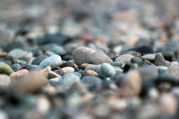 Stone pebbles on a beach. Ñloseup image, focus is in the middle.