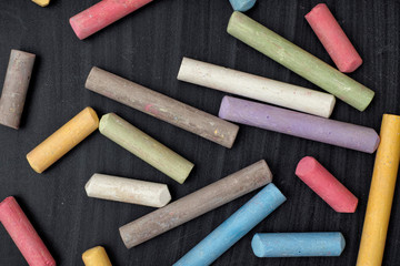 Colorful chalks on blackboard