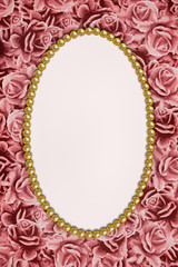 background of pink roses and oval frame made of pearls