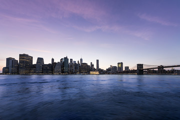 Fototapeta na wymiar New York City Manhattan skyline and cityscape at twilight with Brooklyn Bridge 