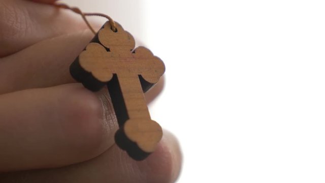 Woman praying and holding Christian cross in hands 4K 2160p UHD footage - Woman holding cross while practicing prayers 4K 3840X2160 UHD video 