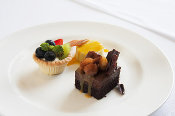 Mini Assorted Fruit Tartlets, Cream of Mango Pudding, Chocolate and Caramel Fondant.