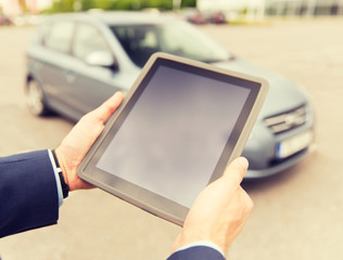 close up of young man with tablet pc and car