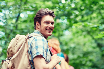 Naklejka na ściany i meble group of smiling friends with backpacks hiking
