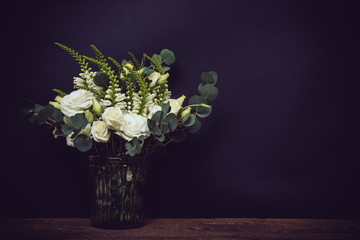 white flowers on an old wooden board with black chalkboard