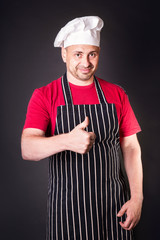 Portrait of a cook man doing success symbol