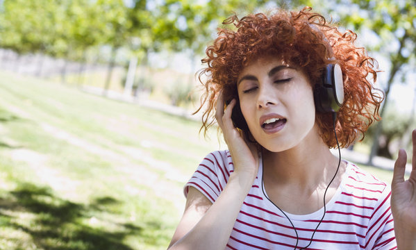 Young beautiful brunette woman girl listening music with headphones