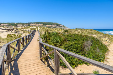 Fototapeta na wymiar Foot bridge at Cala Mesquida - beautiful coast of island Mallorca, Spain