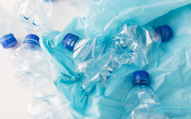 close up of used plastic bottles and rubbish bag