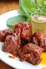 Chinese sweet and sour pork ribs on white plate.