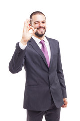 Young business man showing Ok sign, isolated on white background