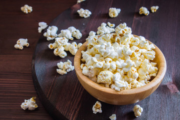 Salt popcorn on the wooden table
