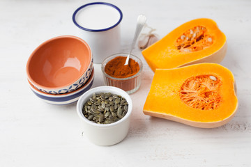 Spicy butternut squash ingredients on the white wooden table, selective focus on the squash