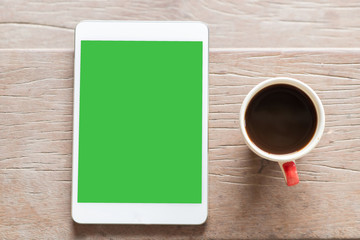 digital tablet with coffee. All with isolated screen on old wood