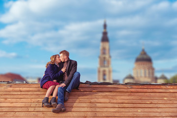 Couple kissing on wooden roof