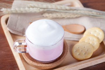 Fototapeta na wymiar close up hot pink milk with biscuits on wooden plate on wooden t