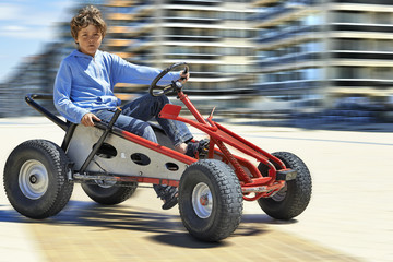Young boy driving a Quadricycle