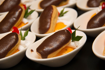  Chocolate eclair pastry on a white cup
