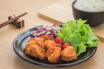 Fried chicken with vegetables on plate and rice in bowl, Japanese food
