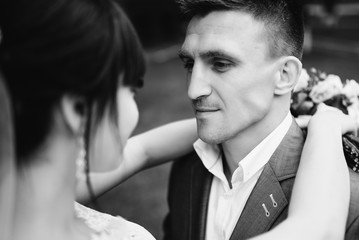 Bride and groom at wedding Day walking Outdoors on summer nature. Bridal couple, Happy Newlywed woman and man embracing. Loving wedding couple outdoor.  Black and white