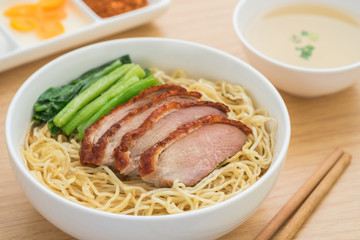 Roasted duck with noodles in bowl and soup